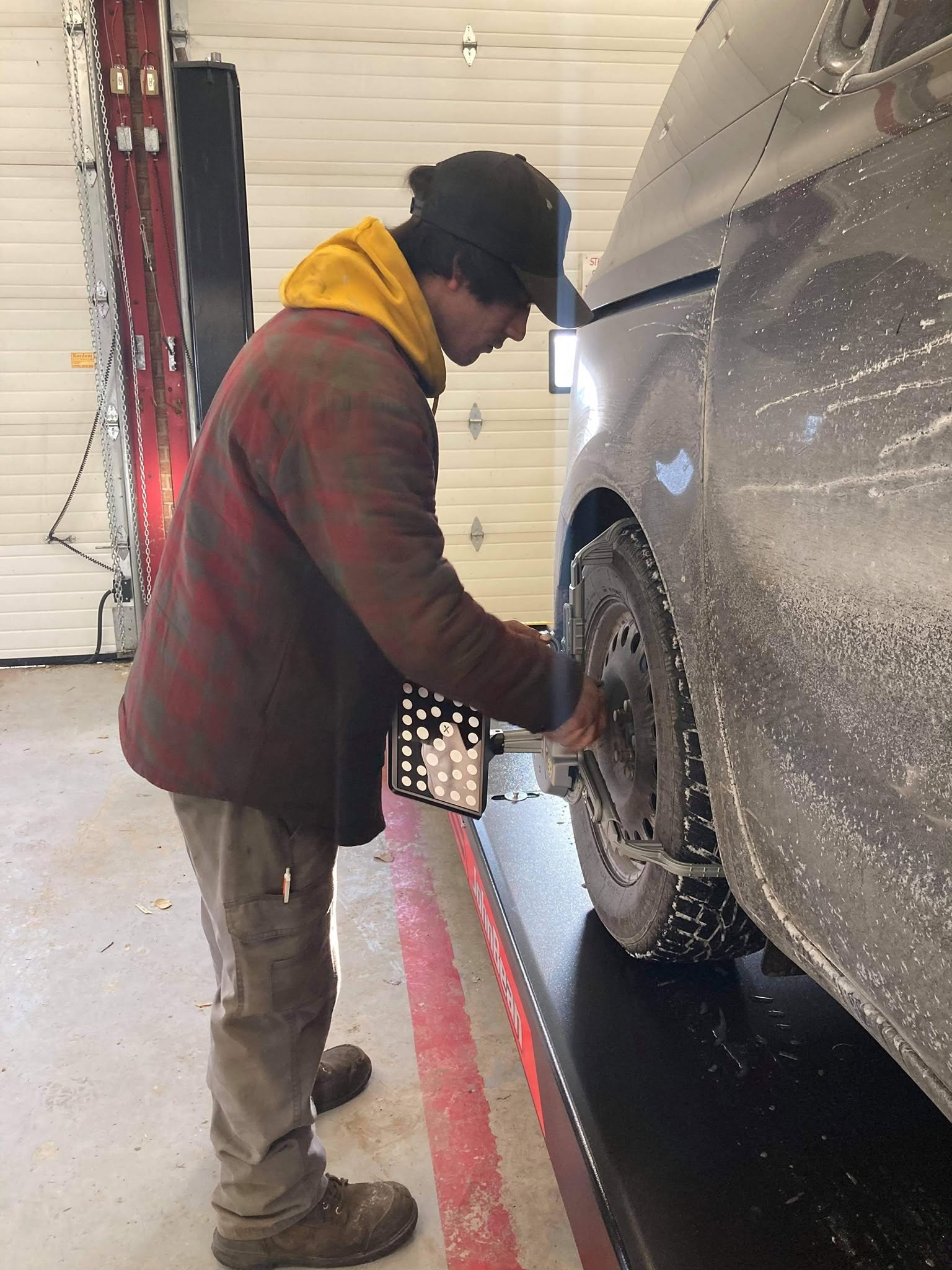 Austin performing wheel alignment